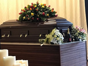 casket with funeral wreath
